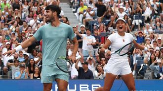 Britain's Emma Raducanu and Carlos Alcaraz of Spain celebrate a point during their first round mixed doubles match against Jessica Pegula of the US and Jack Draper of Britain at the US Open tennis tournament at the USTA Billie Jean King National Tennis Center in New York City on August 19, 2025. 
TIMOTHY A. CLARY / AFP