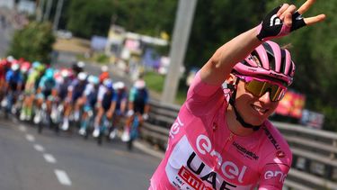 Team UAE's Slovenian rider Tadej Pogacar wearing the overall leader's pink jersey gestures a victory sign as he cycles during the 21st and last stage of the 107th Giro d'Italia cycling race, 125km from Rome to Rome on May 26, 2024.
 
Luca Bettini / AFP