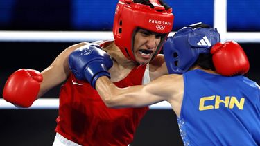 epa11541270 Imane Khelif of Algeria (red) and Yang Liu of China fight in their Women's 66kg Final bout of the Boxing competitions in the Paris 2024 Olympic Games, at Roland Garros in Paris, France, 09 August 2024.  EPA/MAST IRHAM