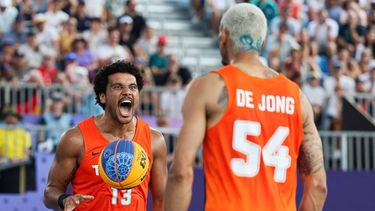 Netherlands' #13 Dimeo van der Horst celebrates with Netherlands' #54 Worthy de Jong after winning the men's pool round 3x3 basketball game between Poland and the Netherlands during the Paris 2024 Olympic Games at La Concorde in Paris on August 2, 2024. 
David GRAY / AFP