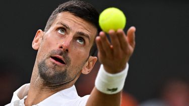 Serbia's Novak Djokovic serves the ball to Australia's Alexei Popyrin during their men's singles tennis match on the sixth day of the 2024 Wimbledon Championships at The All England Lawn Tennis and Croquet Club in Wimbledon, southwest London, on July 6, 2024. 
ANDREJ ISAKOVIC / AFP