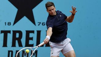 Belgium's Alexander Blockx returns the ball to Canada's Felix Auger-Aliassime during their 2026 ATP Tour Madrid Open tennis tournament third round singles match at the Caja Magica in Madrid, on April 27, 2026.  
OSCAR DEL POZO / AFP