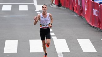 Belgium's Koen Naert  arrives at the finish line in the men's marathon final during the Tokyo 2020 Olympic Games in Sapporo on August 8, 2021. 
Charly TRIBALLEAU / AFP