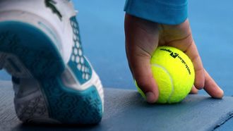 epa03068585 A ball boy hold a tennis ball with Australian Open logo printed on it during the men's singles third round match between Philipp Kohlschreiber of Germany and Alejandro Falla of Colombia at the Australian Open Grand Slam tennis tournament in Melbourne, Australia, 20 January 2012.  EPA/MAST IRHAM