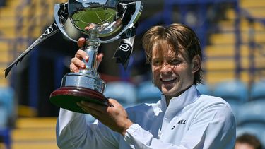 Belgium's Zizou Bergs poses with the winner's trophy after beating France's Ugo Humbert in their men's final tennis match on day seven of the Lexus Eastbourne Open at Devonshire Park, Eastbourne, on the south coast of England on June 28, 2026. 
Glyn KIRK / AFP