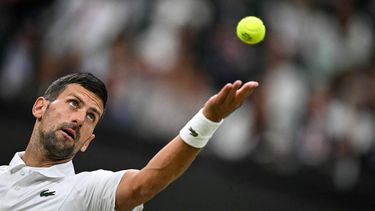 Serbia's Novak Djokovic serves the ball to Denmark's Holger Rune during their men's singles tennis match on the eighth day of the 2024 Wimbledon Championships at The All England Lawn Tennis and Croquet Club in Wimbledon, southwest London, on July 8, 2024. 
Ben Stansall / AFP