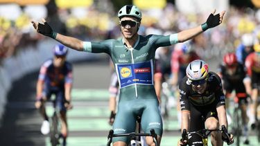 Lidl - Trek team's Italian rider Jonathan Milan wearing the best sprinter's green jersey cycles to the finish line to win ahead of Team Visma - Lease a bike team's Belgian rider Wout van Aert (R) placing second after the 8th stage of the 112th edition of the Tour de France cycling race, 171.4 km between Saint-Meen-le-Grand and Laval Espace Mayenne, western France, on July 12, 2025. 
Marco BERTORELLO / AFP