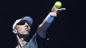 epa11080765 Tallon Griekspoor of the Netherlands serves against Roman Safiullin of Russia during the Women's 1st round match at the Australian Open tennis tournament in Melbourne, Australia, 16 January 2024.  EPA/MAST IRHAM