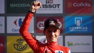2023-09-14 18:17:58 Team Jumbo-Visma's US rider Sepp Kuss wearing the overall leader's red jersey celebrates on the podium after the stage 18 of the 2023 La Vuelta cycling tour of Spain, a 178,9 km race between Pola de Allande and Puerto de La Cruz de Linares on September 14, 2023. 
MIGUEL RIOPA / AFP