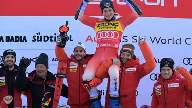 First placed Switzerland's Marco Odermatt celebrates with his team on the podium  of the men's Giant Slalom, during the FIS Alpine Ski World Cup in Alta Badia on December 18, 2023.  
Tiziana FABI / AFP