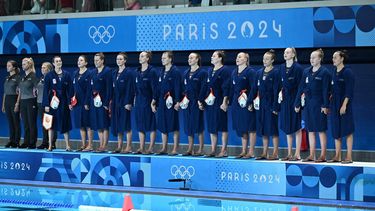 Netherlands' players stand for the national anthem before the women's water polo preliminary round group A match between Netherlands and Australia during the Paris 2024 Olympic Games at the Aquatics Centre in Saint-Denis, north of Paris, on July 31, 2024. 
Andreas SOLARO / AFP