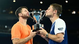 epaselect epa12693865 Christian Harrison (L) of the USA and Neal Skupski (R) of Great Britian pose with the winners trophy after winning the men’s doubles final against Jason Kubler and Marc Polmans  of Australia on day 14 of the 2026 Australian Open tennis tournament at Melbourne Park in Melbourne, Australia, 31 January 2026.  EPA/JOEL CARRETT AUSTRALIA AND NEW ZEALAND OUT