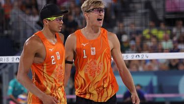 Netherlands' #01 Steven Van De Velde and Netherlands' #02 Matthew Immers celebrate a point in the men's round of 16 beach volleyball match between Brazil and Netherlands during the Paris 2024 Olympic Games at the Eiffel Tower Stadium in Paris on August 4, 2024. 
Thomas SAMSON / AFP