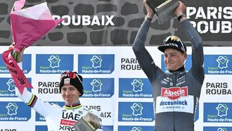 Second placed UAE Team Emirate's Slovenian rider Tadej Pogacar (L) and First placed Alpecin-Deceuninck's Dutch rider Mathieu van der Poel (R) celebrate on the podium of the 122nd edition of the Paris-Roubaix one-day classic cycling race, 259,2 km between Compiegne and Roubaix, northern France on April 13, 2025. 
Jeff PACHOUD / AFP