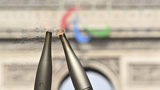 A photo shows the Olympic flame on the Champs-Elysees avenue, in front of the Arc de Triomphe, during the Olympic torch relay in Paris, on July 15, 2024, ahead of the upcomming Paris 2024 Olympic and Paralympic Games. 
JULIEN DE ROSA / AFP