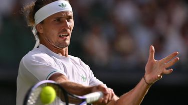 Germany's Alexander Zverev plays a forehand return to France's Arthur Rinderknech during their men's singles first round tennis match on the second day of the 2025 Wimbledon Championships at The All England Lawn Tennis and Croquet Club in Wimbledon, southwest London, on July 1, 2025. 
Glyn KIRK / AFP