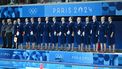 Netherlands' players stand for the national anthem before the women's water polo preliminary round group A match between Netherlands and Australia during the Paris 2024 Olympic Games at the Aquatics Centre in Saint-Denis, north of Paris, on July 31, 2024. 
Andreas SOLARO / AFP