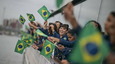 Athletes from  Brazil's delegation wave Brazilian flags as they sail in a boat along the river Seine at the start of the opening ceremony of the Paris 2024 Olympic Games in Paris on July 26, 2024. 
CARL DE SOUZA / POOL / AFP