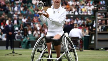 Netherlands' Diede De Groot poses with the winner's trophy after beating Netherlands' Aniek Van Koot in the women's wheelchair singles final tennis match on the thirteens day of the 2024 Wimbledon Championships at The All England Lawn Tennis and Croquet Club in Wimbledon, southwest London, on July 13, 2024. De Groot won the match 6-4, 6-4.
HENRY NICHOLLS / AFP