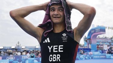 epa11511446 Alex Yee of Great Britain celebrates after the Men Individual race of the Triathlon competitions from a Metro entrance in the Paris 2024 Olympic Games, at the Pont Alexandre III in Paris, France, 31 July 2024.  EPA/TOLGA AKMEN