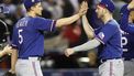 2023-10-30 19:56:09 epa10949879 Texas Rangers shortstop Corey Seager (L) is greeted by Texas Rangers catcher Mitch Garver (R) after the Texas Rangers won game three of the Major League Baseball (MLB) World Series between the  Arizona Diamondbacks and the Texas Rangers at Chase Field in Phoenix, Arizona, USA 30 October 2023. The best of seven World Series is tied 1-1.  EPA/JOHN G MABANGLO