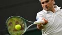 US player Marcos Giron returns the ball to Germany's Alexander Zverev during their men's singles tennis match on the fourth day of the 2024 Wimbledon Championships at The All England Lawn Tennis and Croquet Club in Wimbledon, southwest London, on July 4, 2024. 
Glyn KIRK / AFP