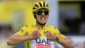 epa11476119 Yellow jersey Slovenian rider Tadej Pogacar of UAE Team Emirates celebrates as he crosses the finish line to win the 14th stage of the 2024 Tour de France cycling race over 151km from Pau to Saint-Lary-Soulan Pla d'Adet, France, 13 July 2024.  EPA/GUILLAUME HORCAJUELO