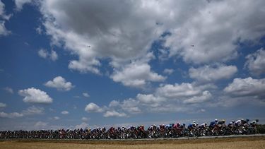 The pack of riders (peloton) cycles during the 13th stage of the 113th edition of the Tour de France cycling race, 205,8 km between Dole and Belfort in eastern France, on July 17, 2026. 
Anne-Christine POUJOULAT / AFP