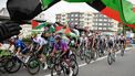 Pro-Palestinian protesters wave flags and shout as the peloton rides by in Poio at the start of the 16th stage of the Vuelta a Espana, a 172 km race between Poio and Castro de Herville, on September 9, 2025.   
Miguel RIOPA / AFP