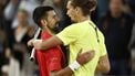 epa12156245 Novak Djokovic of Serbia (L) hugs at the net after winning his Men's singles quarter-finals match against Alexander Zverev of Germany (R) at the French Open Grand Slam tennis tournament at Roland Garros in Paris, France, 04 June 2025.  EPA/YOAN VALAT