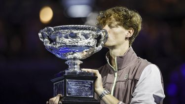 epa11110507 Jannik Sinner of Italy kisses the Norman Brookes Challenge Cup trophy after winning the Men's Singles final match against Daniil Medvedev of Russia at the 2024 Australian Open tennis tournament, in Melbourne, Australia, 28 January 2024.  EPA/MAST IRHAM