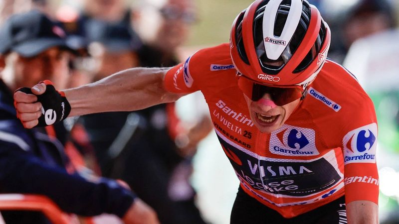 Overall leader team Visma-Lease a bike's Danish rider Jonas Vingegaard celebrates as he crosses the finish line to win the 20th stage of the Vuelta a Espana 2025, a 156 km race between Robledo de Chavela and Bola del Mundo, near Navacerrada, on September 13, 2025.   
Oscar DEL POZO / AFP