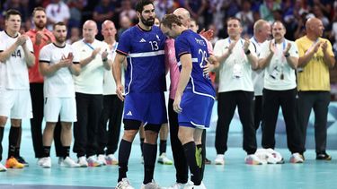 France's left back #13 Nikola Karabatic (CL) and France's right wing #28 Valentin Porte react after being defeated by Germany at the end of the men's quarter-final handball match between Germany and France of the Paris 2024 Olympic Games, at the Pierre-Mauroy stadium in Villeneuve-d'Ascq, northern France, on August 7, 2024. 
Sameer Al-Doumy / AFP