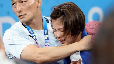 epa11501675 Uta Abe of Japan is consoled by a coach after losing her bout in the Women -52kg Elimination Round of 16 of the Judo competitions in the Paris 2024 Olympic Games, at the Champs-de-Mars Arena in Paris, France, 28 July 2024.  EPA/DANIEL IRUNGU