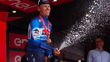 Team Soudal-Quick Step's Belgian rider Tim Merlier sprays champagne on the podium after winning the 18th stage of the 107th Giro d'Italia cycling race, 178km between Fiera di Primiero and Padua on May 23, 2024. 
Luca Bettini / AFP