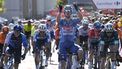 Team Alpecin's Kaden Groves celebrates crossing the finish in first place followed by Team Visma's Wout van Aert (R) and Team Israel Premier Tech 's Corbin Strong (L) at the end of the stage 2 of La Vuelta a Espana cycling tour, a 194 km race between Cascais and Ourem, on August 18, 2024.   
MIGUEL RIOPA / AFP