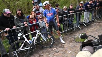 Alpecin-Premier Tech's Dutch rider Mathieu van der Poel waits to change his bike after a flat tire at the 'Trouée d’Arenberg' cobblestone sector (Arenberg trench) during the 123rd edition of the Paris-Roubaix one-day classic cycling race, 258.3 km between Compiègne and Roubaix, northern France, on April 12, 2026.  
Etienne GARNIER / POOL / AFP
