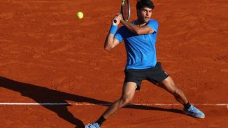 Spain's Carlos Alcaraz returns to Argentina's Tomas Martin Etcheverry during their Monte Carlo ATP Masters Series Tournament round of 16 tennis match on Court Rainier III at the Monte-Carlo Country Club in Roquebrune-Cap-Martin, south-eastern France on April 9, 2026. 
Valery HACHE / AFP