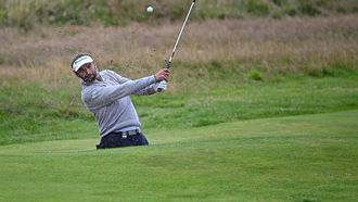 Netherland's Joost Luiten plays out of a bunker on the 18th green on day three of the 151st British Open Golf Championship at Royal Liverpool Golf Course in Hoylake, north west England on July 22, 2023.                                                                                                                The 151st Open at The Royal Liverpool Golf Course is set to run until July 23.
Paul ELLIS / AFP