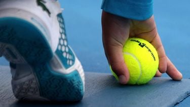 epa03068585 A ball boy hold a tennis ball with Australian Open logo printed on it during the men's singles third round match between Philipp Kohlschreiber of Germany and Alejandro Falla of Colombia at the Australian Open Grand Slam tennis tournament in Melbourne, Australia, 20 January 2012.  EPA/MAST IRHAM