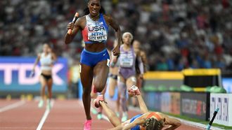 2023-08-19 21:58:57 USA's Alexis Holmes runs past Netherlands' Femke Bol who fell before the finish line in the mixed 4x400m relay final during the World Athletics Championships at the National Athletics Centre in Budapest on August 19, 2023. 
Jewel SAMAD / AFP