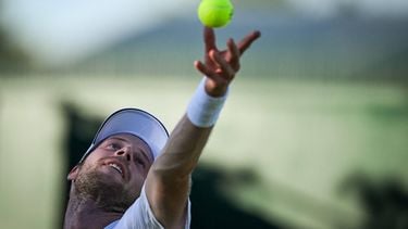 Netherlands' Botic Van De Zandschulp serves the ball to Italy's Matteo Arnaldi during their men's singles first round tennis match on the first day of the 2025 Wimbledon Championships at The All England Lawn Tennis and Croquet Club in Wimbledon, southwest London, on June 30, 2025. 
Kirill KUDRYAVTSEV / AFP