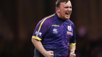 epa11054069 Luke Littler of England reacts as he plays against Rob Cross of England at the semi final match of the Paddy Power World Darts Championship, in London, Britain, 02 January 2024.  EPA/TOLGA AKMEN