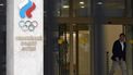 A man walks past the logo of the Russian Olympic Committee (ROC) as he leaves the office in Moscow on October 15, 2024. The head of Russia's Olympic Committee announced his resignation on October 15, 2024, a surprise move that comes as Moscow faces isolation from international sport over its Ukraine offensive. Former fencer, Stanislav Pozdnyakov, a five-time Olympic medallist, said in his resignation letter there were 