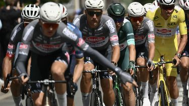 Alpecin - Deceuninck team's Dutch rider Mathieu van der Poel wearing the overall leader's yellow jersey (R) cycles with Alpecin - Deceuninck team's Belgian rider Jasper Philipsen wearing the best sprinter's green jersey (3rd R) and teammates during the 3rd stage of the 112th edition of the Tour de France cycling race, 178.3 km between Valenciennes and Dunkerque (Dunkirk), Northern France, on July 7, 2025. 
Marco BERTORELLO / AFP