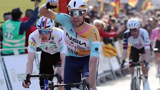 Team NSN Cycling Team's Welsh rider Ethan Vernon (C) celebrates ahead of Team Ineos' French rider Dorian Godon (L), after winning the 4th stage of the 2026 Volta a Catalunya cycling tour of Catalonia, a 151 km race between Mataro and  Camprodon, on March 26, 2026. 
Josep LAGO / AFP