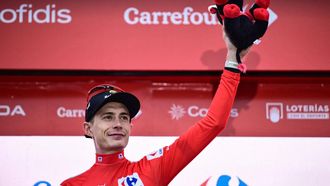Team Visma-Lease a bike's Danish rider Jonas Vingegaard,  wearing the overall leader's red jersey, celebrates on the podium after winning the second stage of the Vuelta a Espana, a 159,6 km race between Alba and Limone Piemonte, in Italy's Piemonte region, on August 24, 2025.   
Marco BERTORELLO / AFP