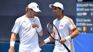 Netherlands' Jean-Julien Rojer (R) and Netherlands' Wesley Koolhof talk during their Tokyo 2020 Olympic Games men's doubles first round tennis match at the Ariake Tennis Park in Tokyo on July 24, 2021. 
Tiziana FABI / AFP