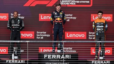 2023-10-22 23:11:33 (L-R) Mercedes' British driver Lewis Hamilton, Red Bull Racing's Dutch driver Max Verstappen and McLaren's British driver Lando Norris listen to the national anthems on the podium after the 2023 United States Formula One Grand Prix at the Circuit of the Americas in Austin, Texas, on October 22, 2023.  
Jim WATSON / AFP