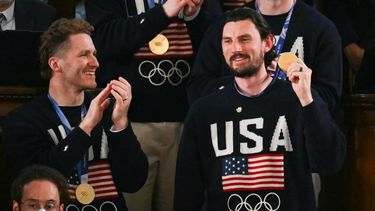 Goalie Connor Hellebuyck raises his gold medal as members of the US Men's Olympic hockey team are recogized by US President Donald Trump as he delivers the State of the Union address in the House Chamber of the US Capitol in Washington, DC, on February 24, 2026. 
ANDREW CABALLERO-REYNOLDS / AFP